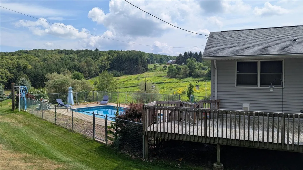 Multi level decks lead from inground pool to open and covered decks