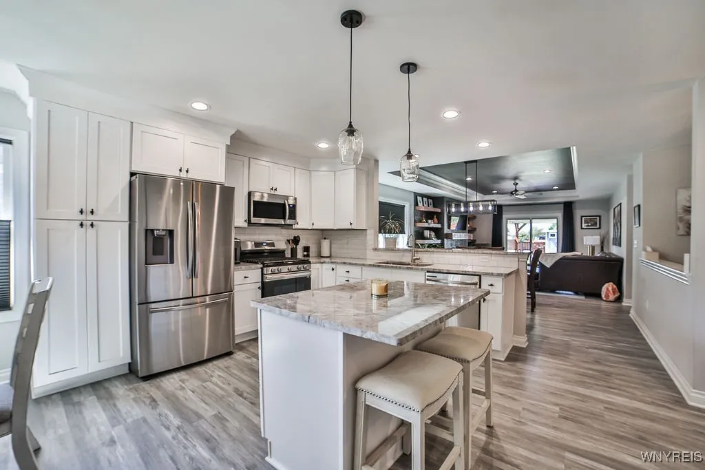 View from front door, kitchen, formal dining room, into living room