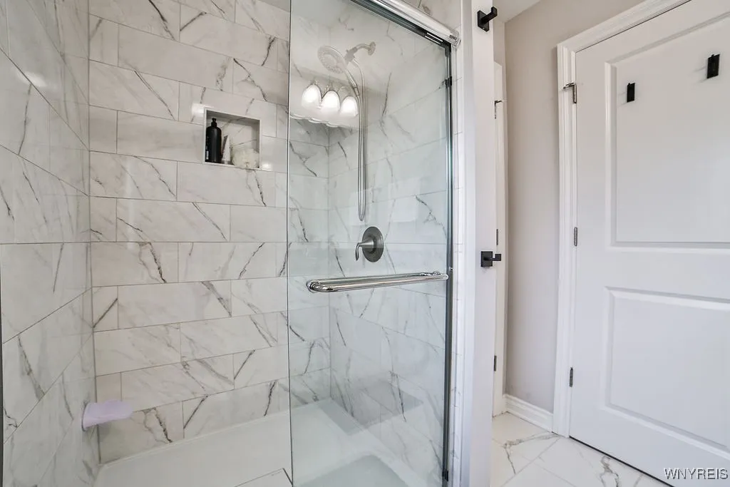 Ceramic tile shower and floors in Primary bath.