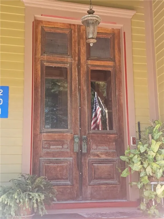 Double wood doors, brass doorknobs.