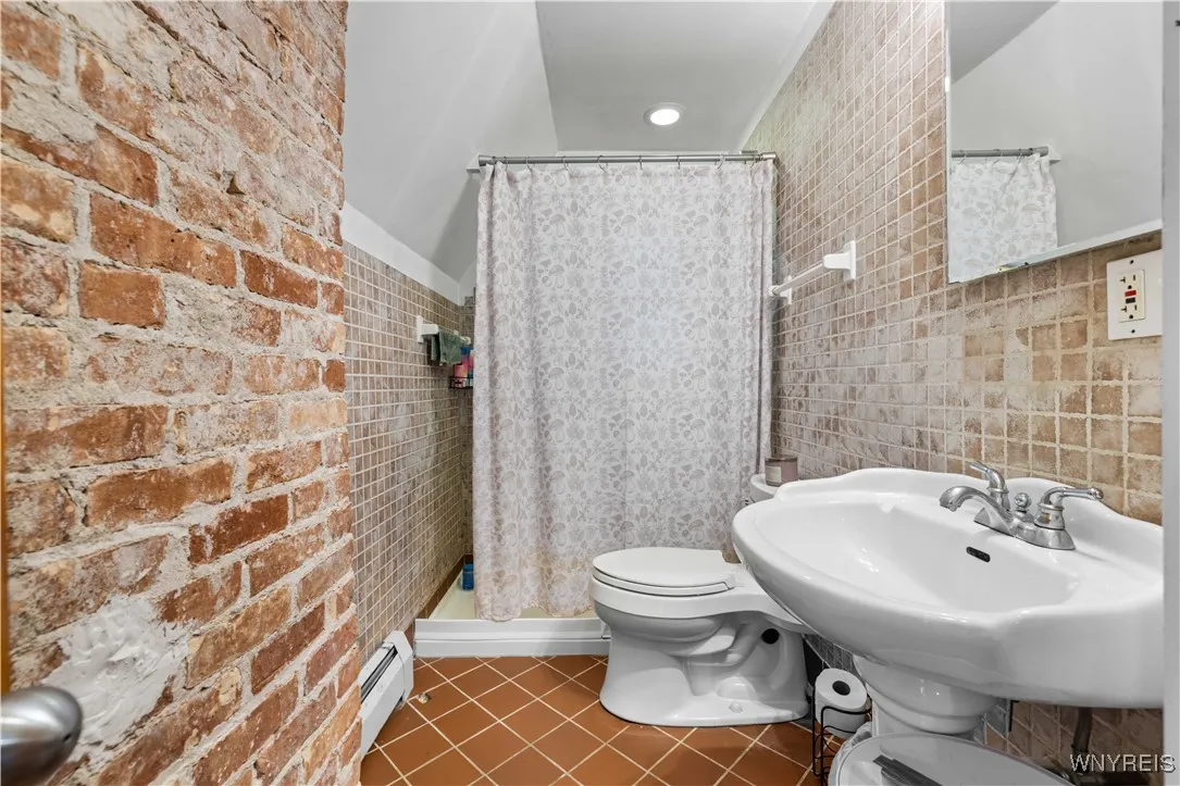 Unit 3 bathroom Wall to ceiling tile and exposed brick