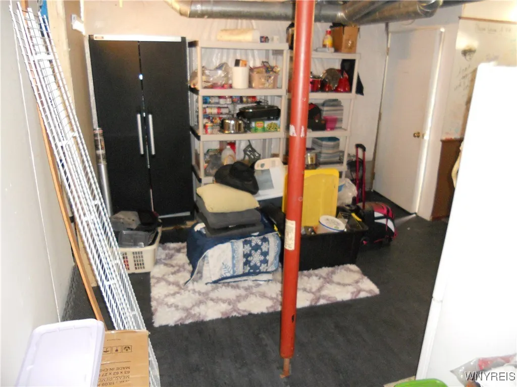 bottom of stairs, (storage) & walk out basement door behind the white door.