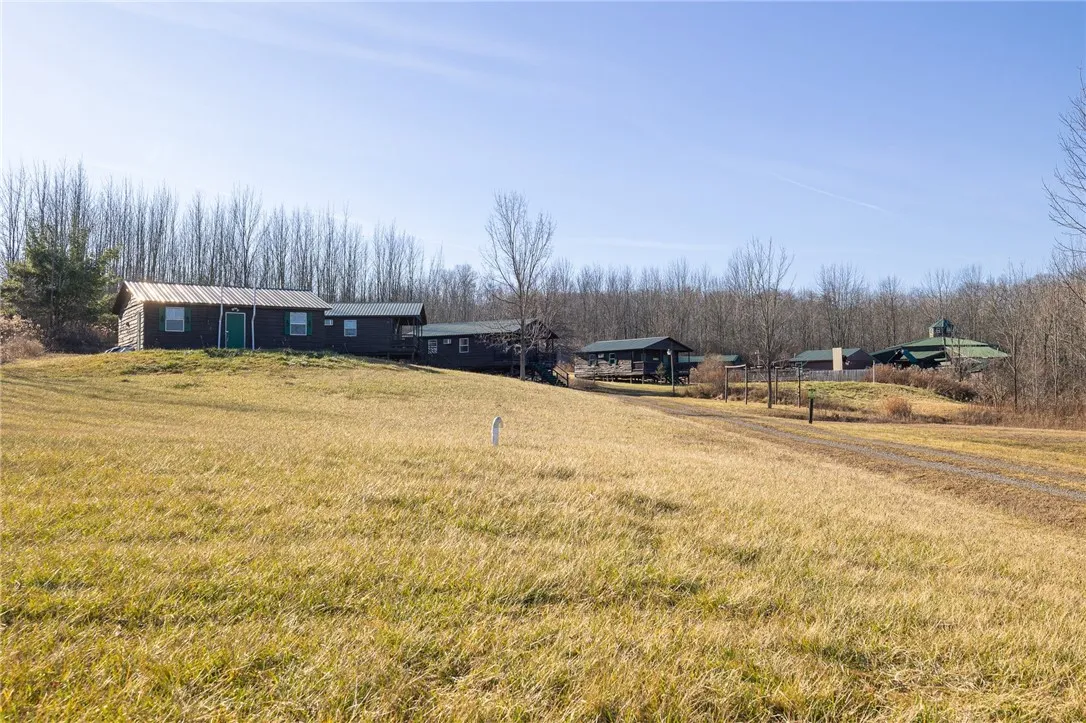 View of bath house, 2 bunk houses, and rec hall.