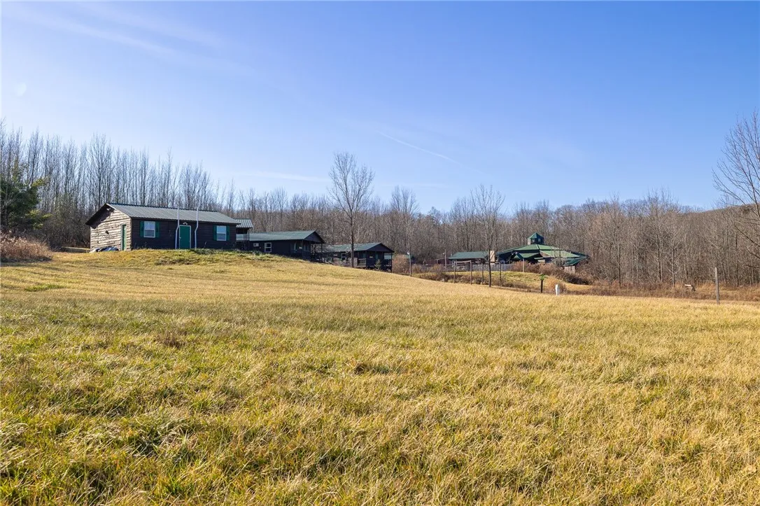 Bath house, two bunk houses and rec hall in the distance.