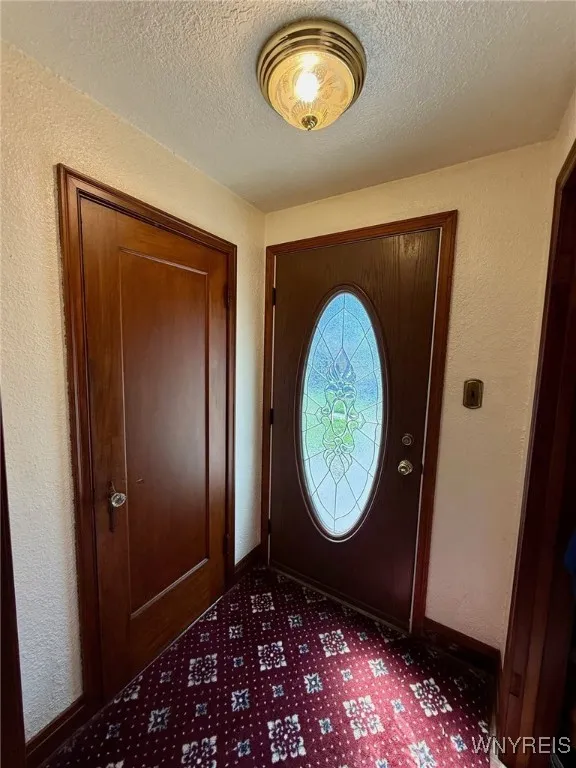 Welcoming foyer with a convenient cedar coat closet and a half bath