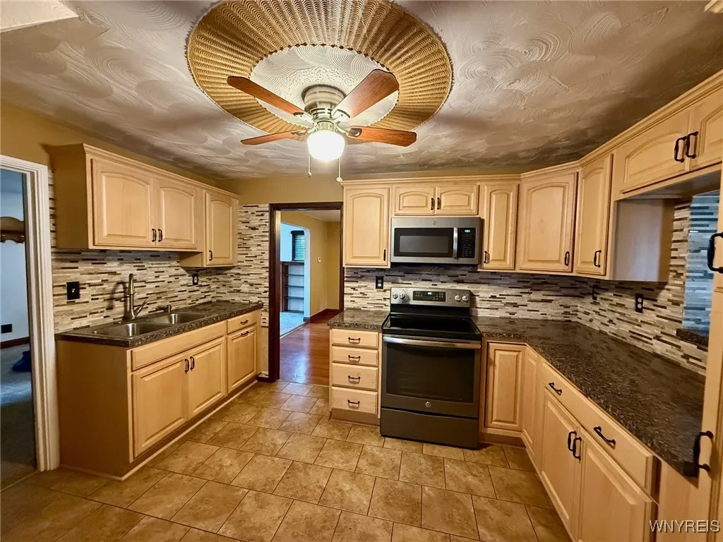 Updated kitchen with tile backsplash, a pantry, and includes appliances.