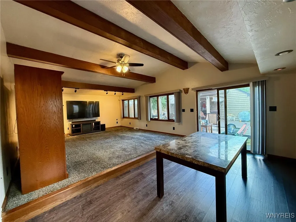 Tons of windows creating a cheerful space, a versatile area—perfect for additional dining, an office area or flexible living space. Sliding door opens to a fully fenced yard for easy indoor-outdoor living.