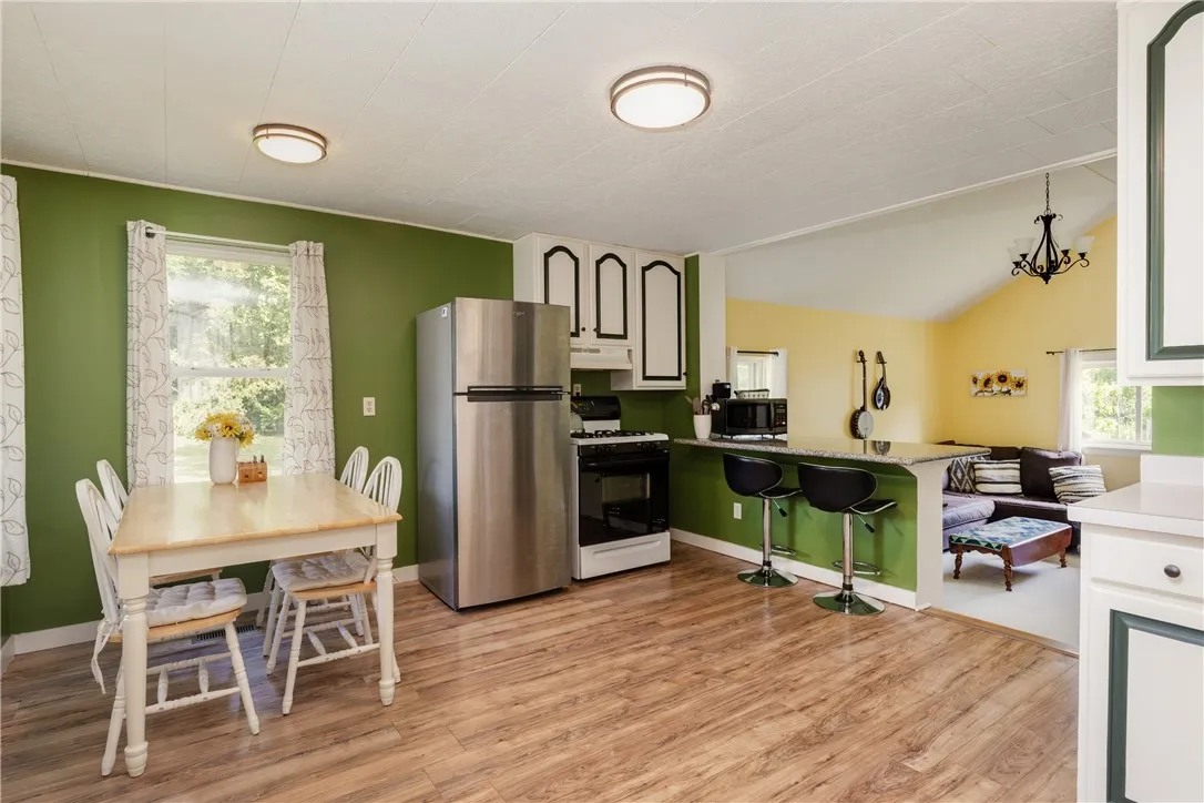 gas stove and stainless refrigerator stay with the house