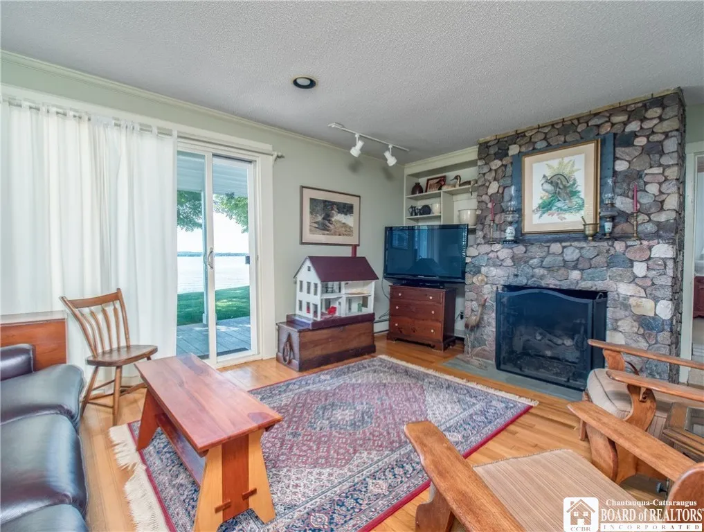 Family room...stone fireplace with gas insert, sliders to the lakefront patio