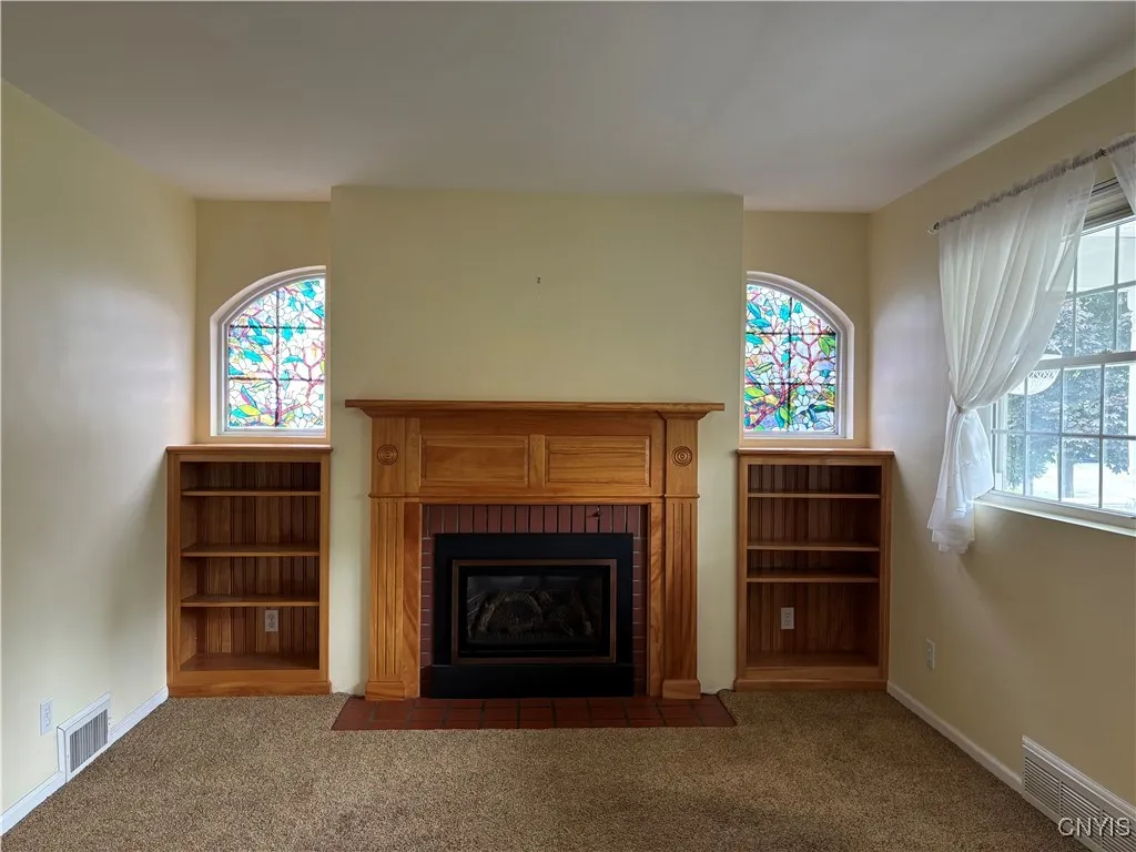Gas frieplace with built in cabinets. Floral design on windows can be easily removed
