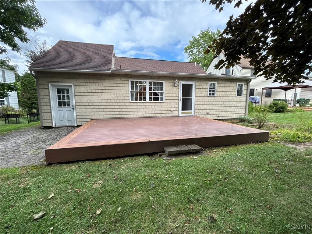 Exterior back with deck and paved patio area