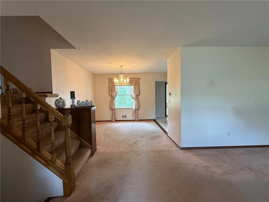 Entrance to formal dining room and stairway to upstairs bedrooms