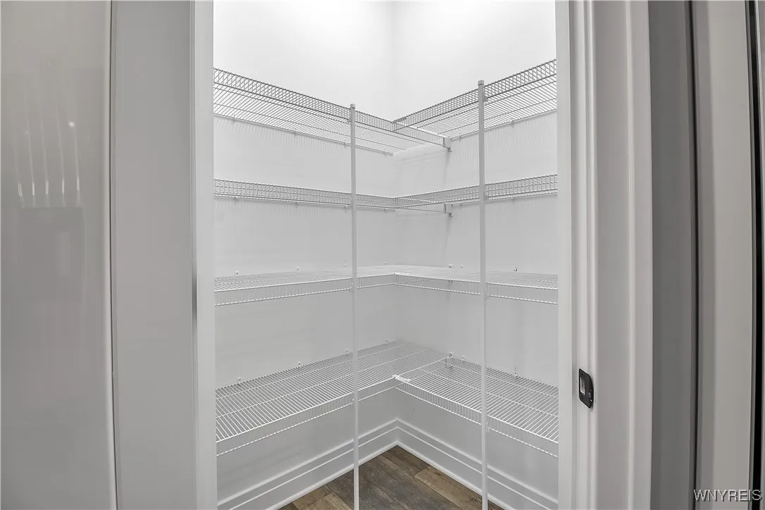 This walk-in pantry offers a ton of storage space for food, kitchen appliances, etc.!