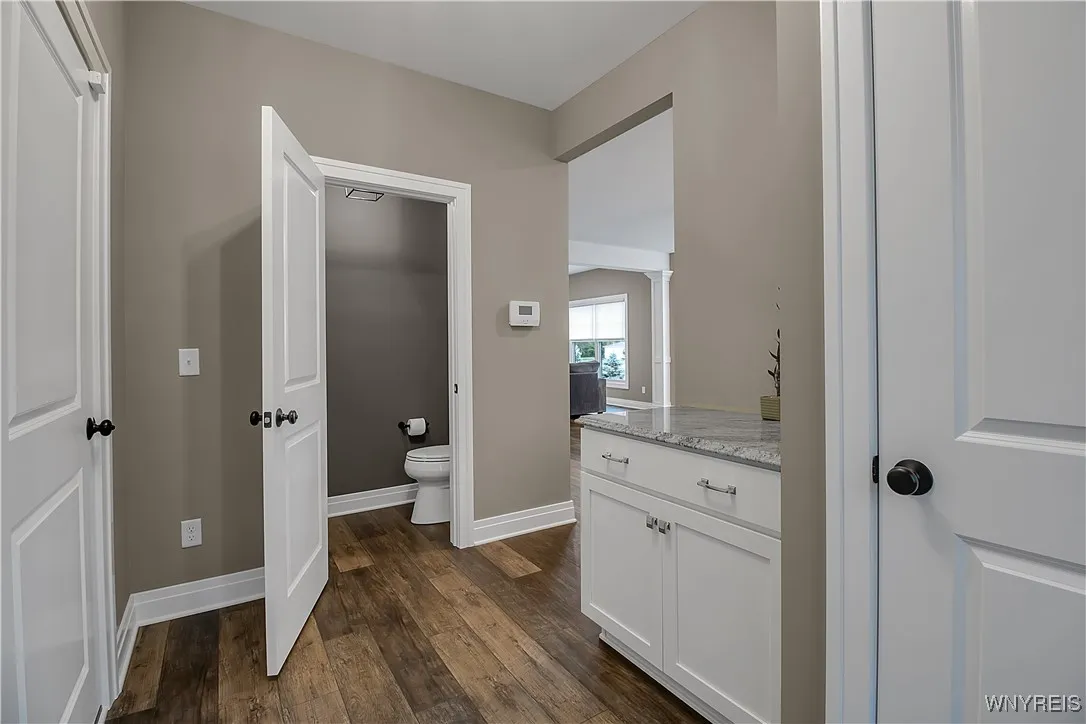 Another view of mud room - there is more cabinet storage and you can see the 1/2 bath here as well