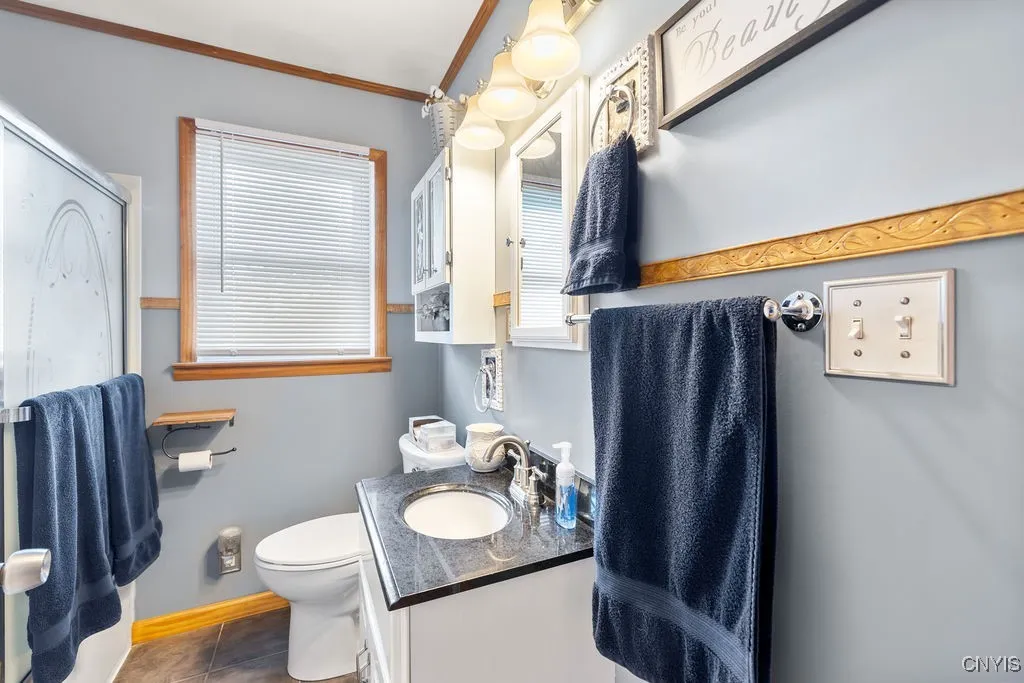 Full shower and bath with sliding glass doors and recent fixtures.