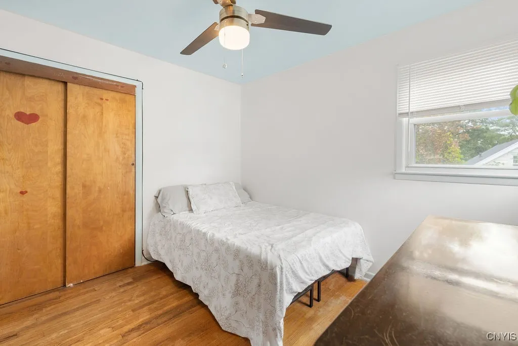 Bedroom 2 is light and bright with a large closet and hardwood floors as well as a light and adjustable speed ceiling fan.