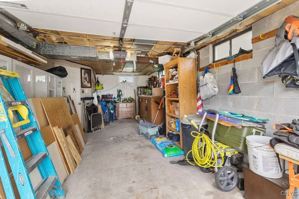 The one car garage features an automatic opener and a workshop in the back. Lots of room for storage and tools.