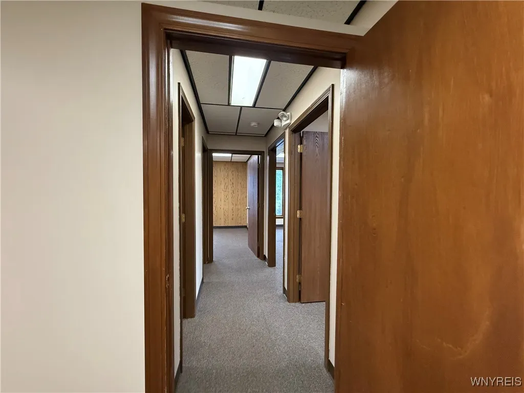 Hallway to three offices and communications closet with hand washing station