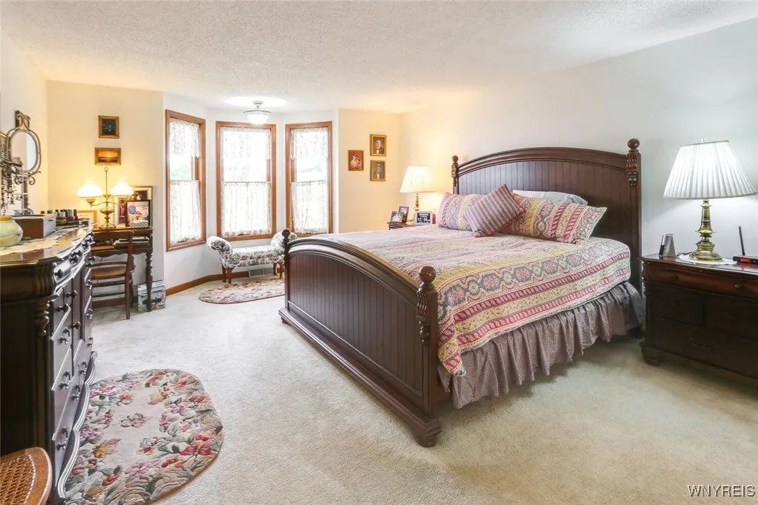 Primary bedroom with bay windows