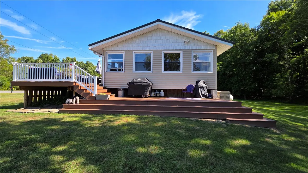 Side view of home with wrap around deck