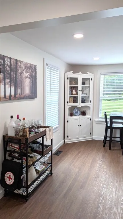 extension of large kitchen shows nice sized windows , corner cabinet and eat in area of kitchen
