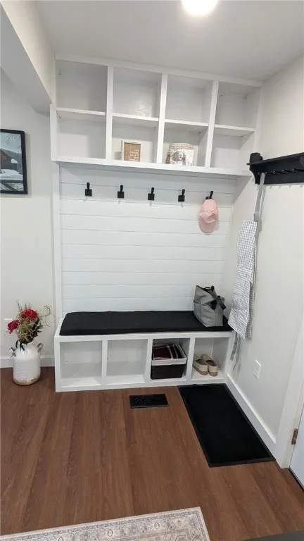 closer view of drop area with  hooks, cubbies, bench