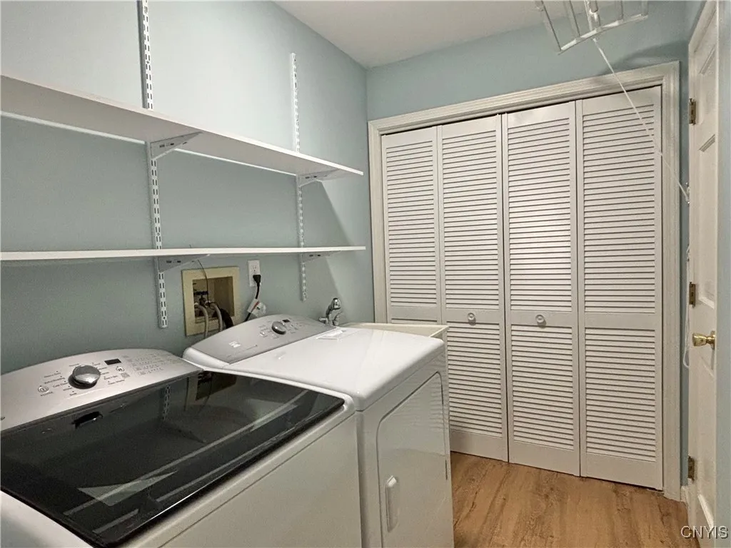 Laundry room.  Notice the laundry sink behind the dryer.  Utilities are behind the louvered doors.