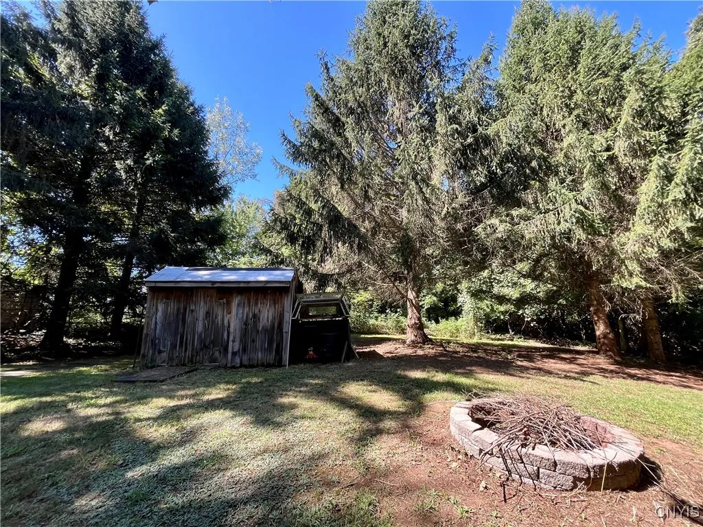 Back yard has campfire pit plus shed for all your tools!