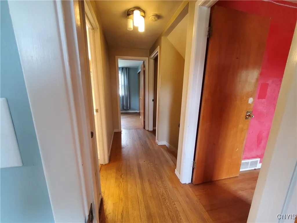 Second floor hallway with hardwood floors.