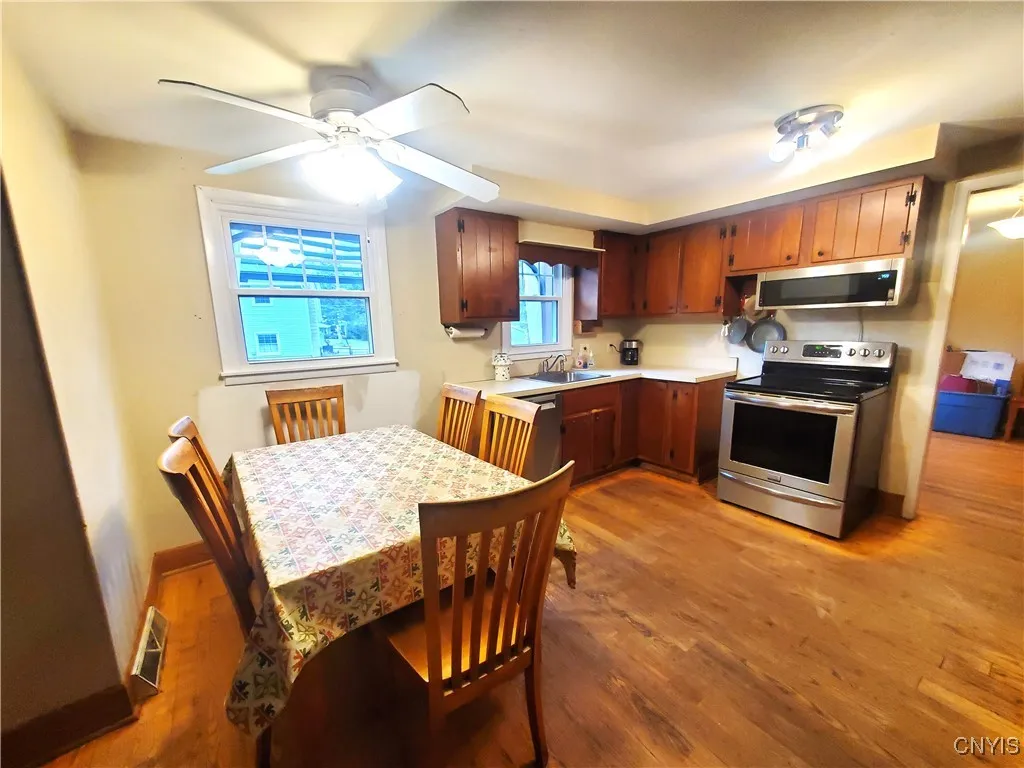 Large kitchen with eating area, ceiling fan. Dining room (right)