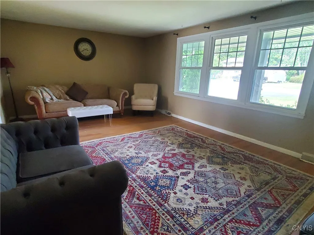 Large livingroom with newer windows overlook the front covered porch