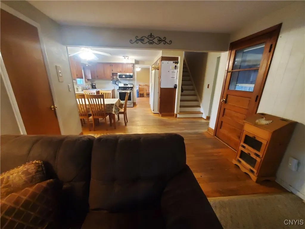 View from the family room to the kitchen (staircase background, right). Door access to garage (right)