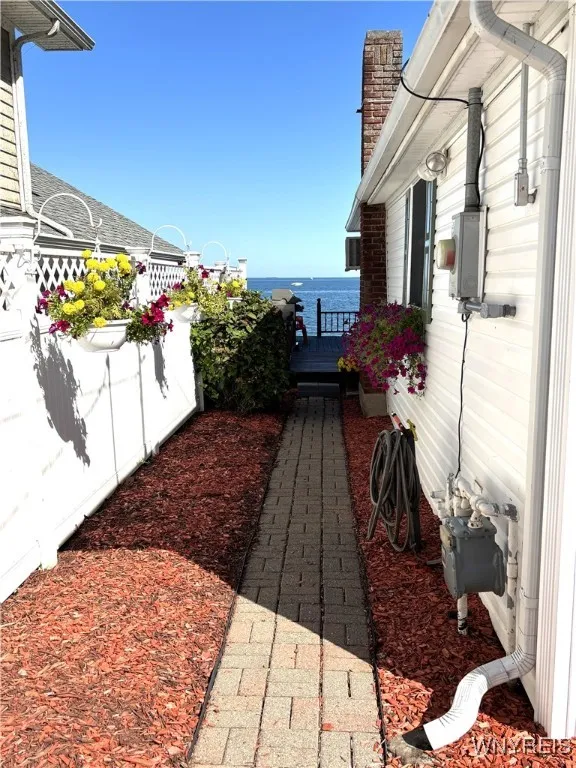 Walkway to lake-front deck from paved courtyard