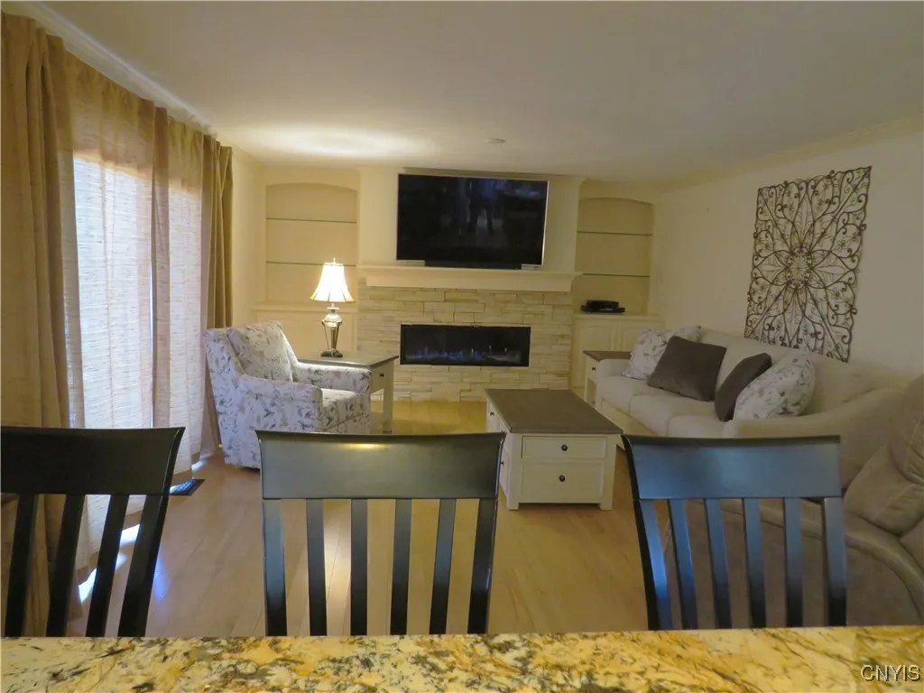 Open kitchen to cozy living room with fireplace