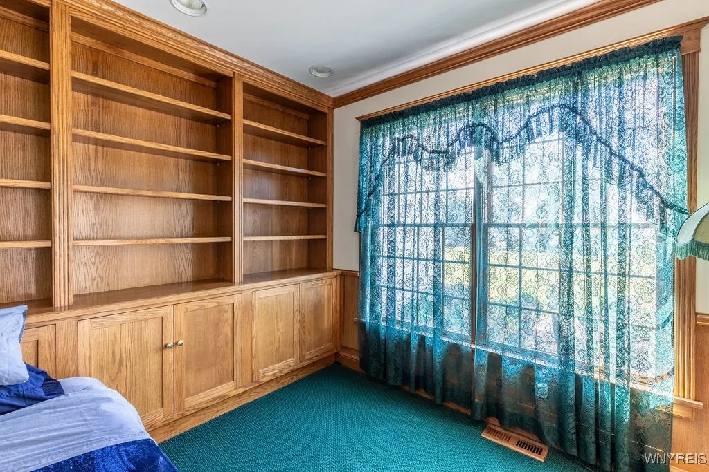 Den with beautiful built-in shelving and lower cabinets