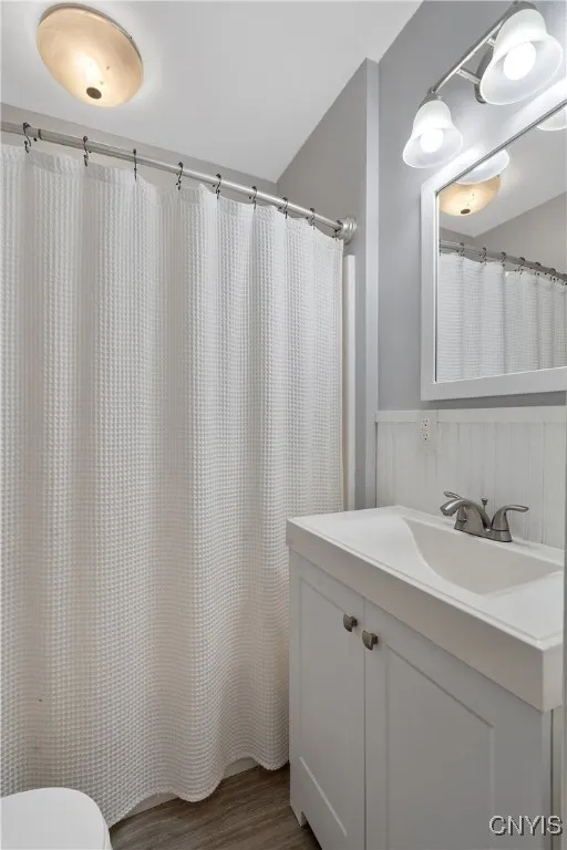 The bathroom is attractively updated with light fixtures, sink and vanity that is sure to complement any decor choices you desire here.