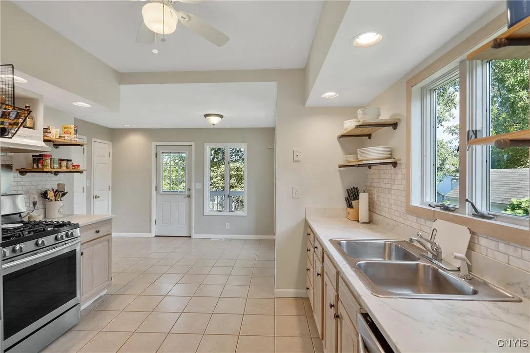What an impressive space! With an open addition at the back of the house, you can add a breakfast nook for those casual meals on the go.  And the modern design of open shelves coupled with storage cabinets below is something out of a magazine!