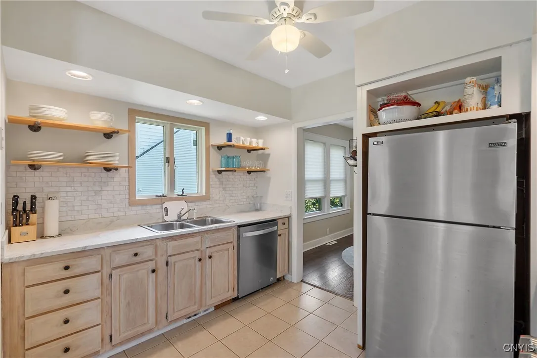 The faux-tile backsplash and recessed overhead lighting are a few more of the attractive touches found in the kitchen.