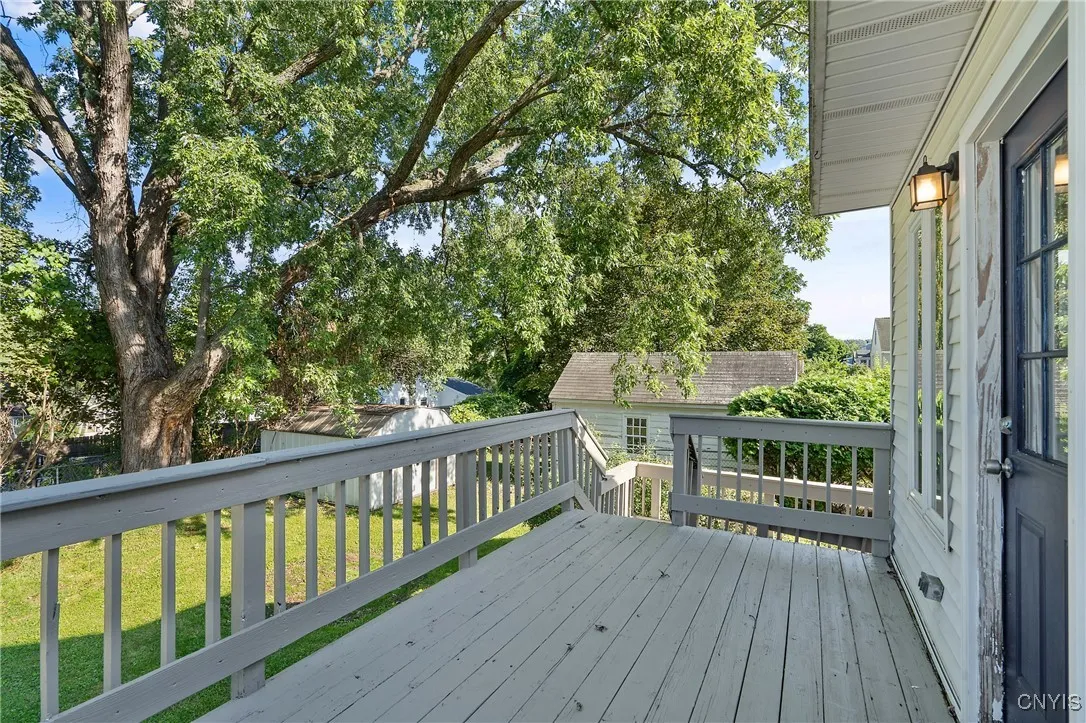 Now we can step outside through the doorway previously seen in the eat-in kitchen. The deck is a great spot for outdoor seating and a BBQ for dining al fresco while overlooking the sweet yard.