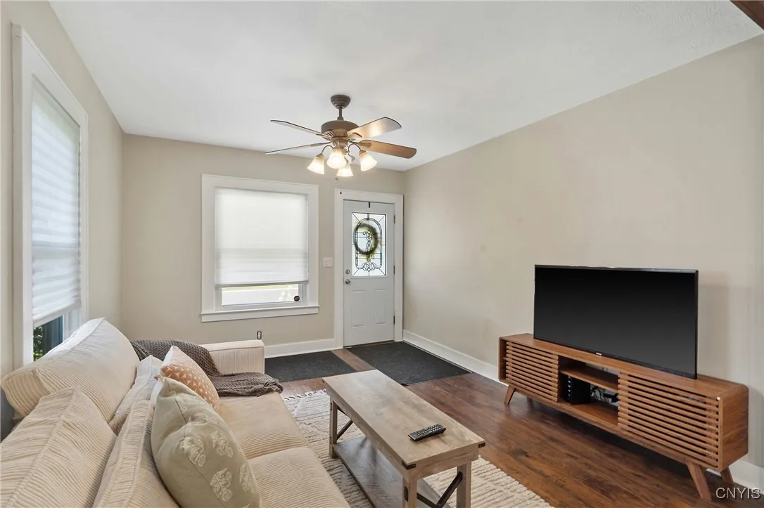 Entering the home, we are greeted by the family room.  New vinyl flooring was installed with a rich wood tone to accent the earth tones of the paint selection throughout most of the home.
