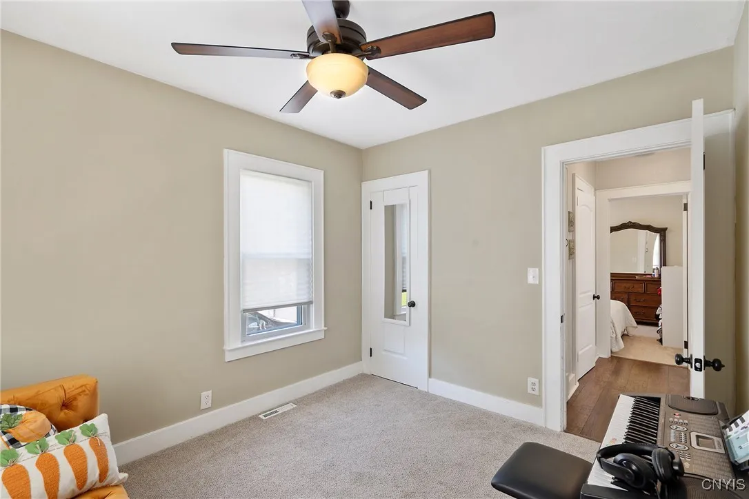 The closet is stashed in the corner here as we also see back into the hallway.  The full bathroom is well situated in between the bedrooms.
