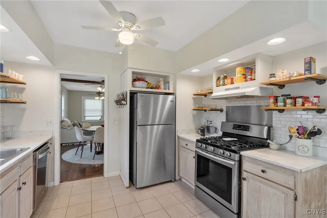 As we make our way back through the house to visit the bedrooms, we can't overlook the ideal design of the kitchen with sink & dishwasher on one side, and fridge & stove on the other.