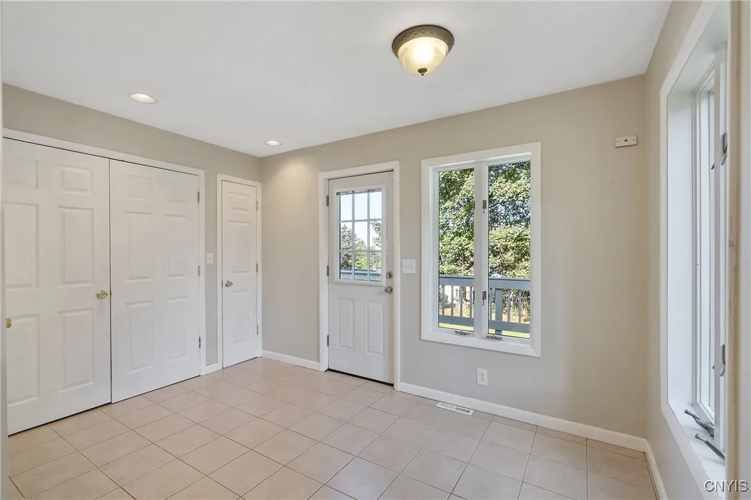 The back half of the kitchen was a well-designed addition added many years ago. Here we see the pedestrian door accessing the back yard and deck, which we will explore later in our tour.  We also see a pantry closet tucked into the corner, as well as the double door closet which is home to the main level washer & dryer.