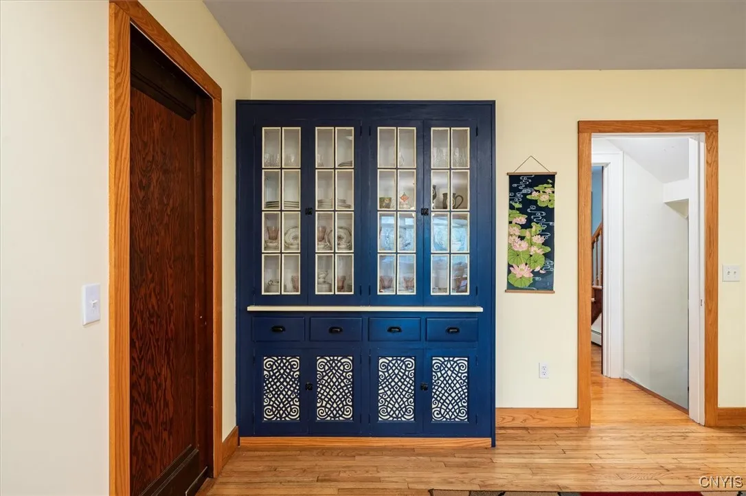 Swing thru door on left opens into kitchen area featuring here the attached dish cupboard