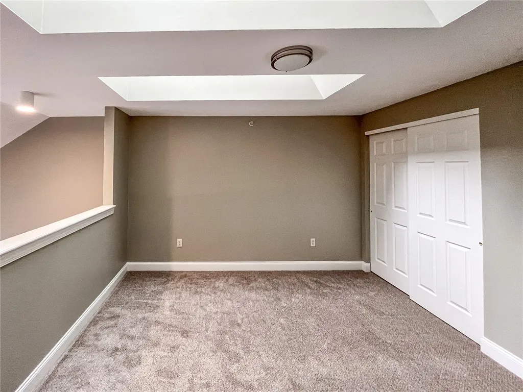 View of typical second floor loft with skylights, and bedroom, walk-in closet and full bathroom