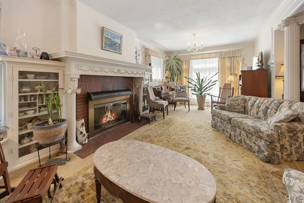 SPACIOUS LIVING ROOM WITH MAGNIFICENT FIREPLACE WITH ORIGINAL BUILT IN CABINETS**