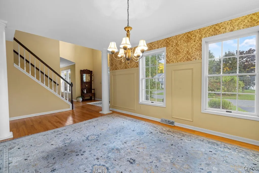 Formal dining room with large windows, nice lighting and hardwood floors makes this space perfect for entertaining