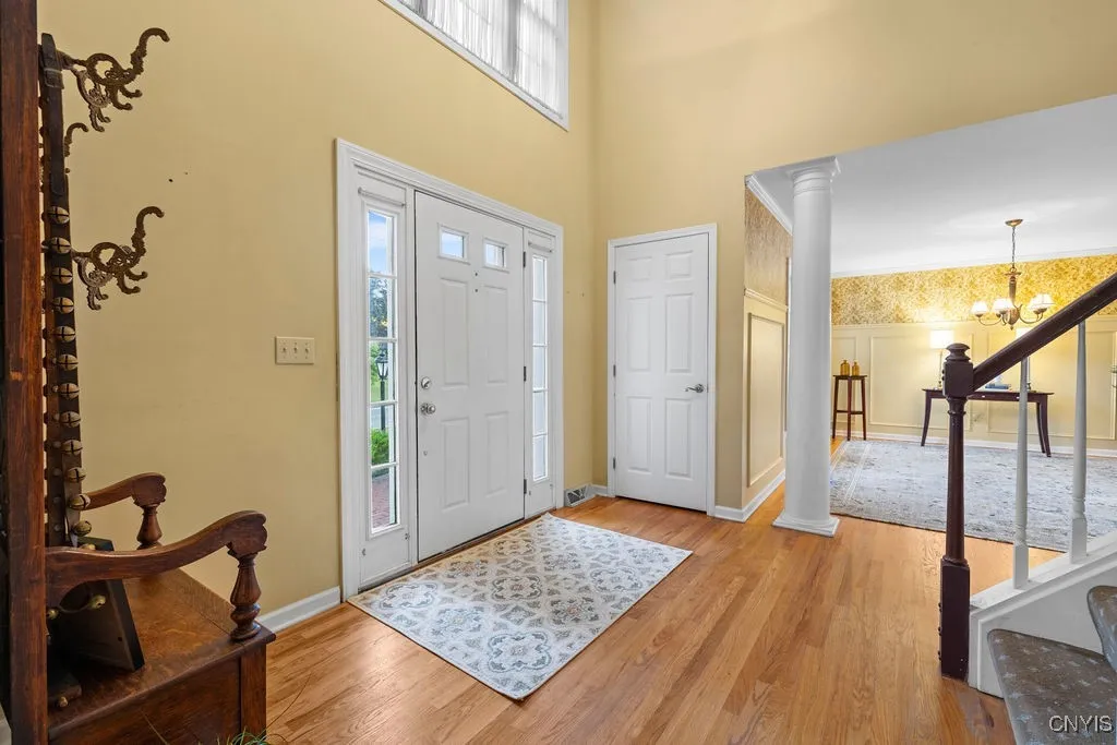The 2 Story Foyer brings in so much natural light and shows off the hardwood flooring.