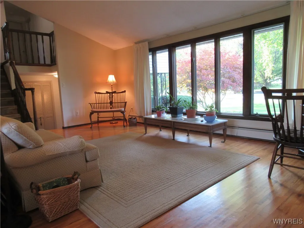 Absolutely Gorgeous Solid Hardwood Flooring !  Large Living Room with Cathedral Ceiling & Natural Lighting!