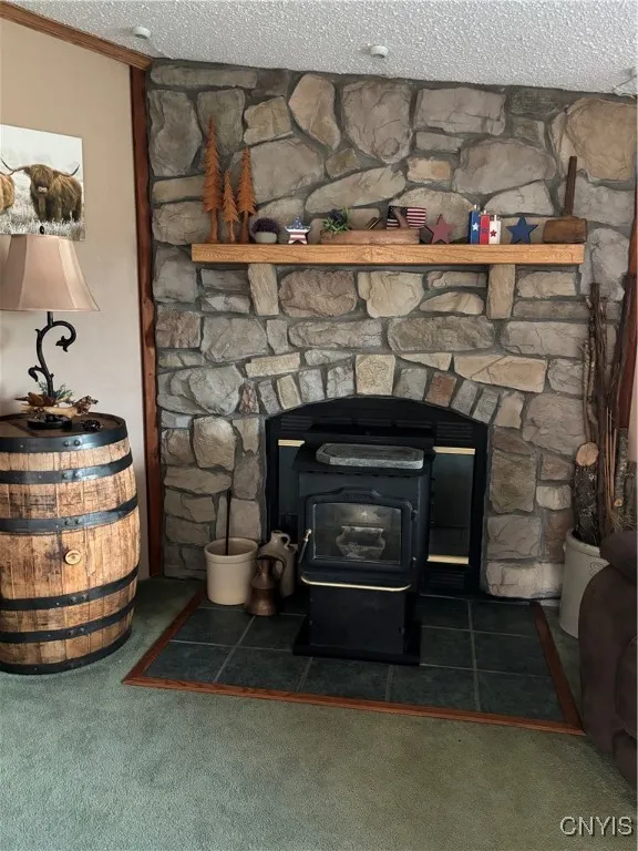Livingroom features a pellet stove highlighted by stone feature